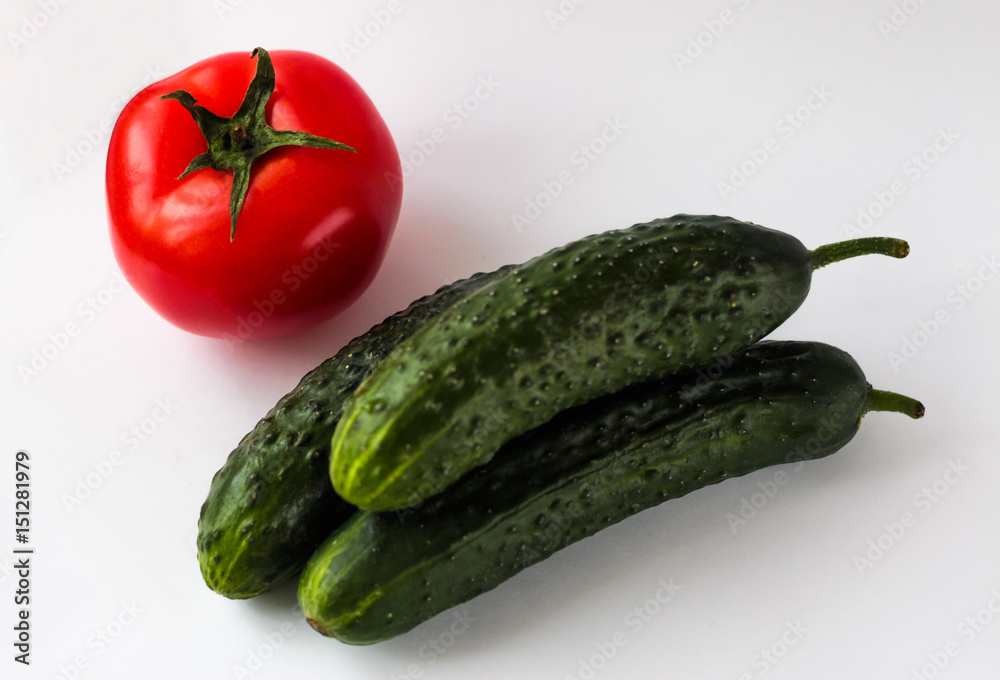 Fresh vegetables, tomatoes and cucumbers on a white background. Vegan Fresh vegetables, tomatoes and cucumbers on a white background. Vegan