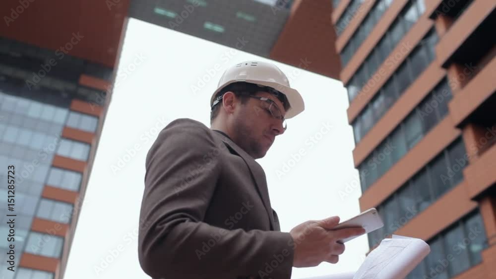 Businessman, Architectin the Helmet Talking on Phone on Background Building Businessman, Architectin the Helmet Talking on Phone on Background Building