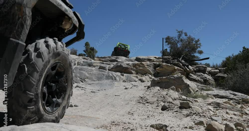 Two off road recreation ATV rock climb steep trail Utah. San Rafael