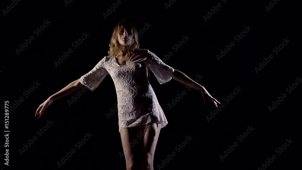 Dynamic meditation a young slender girl in a short white dress Dynamic meditation a young slender girl in a short white dress