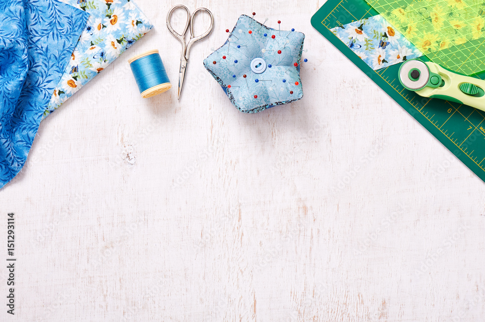 Fototapeta premium Patchwork accessories, top view on a white wooden surface