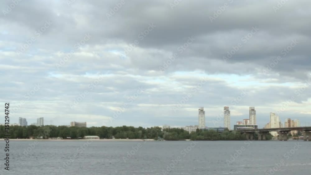 The sky is covered with clouds over a wide river The sky is covered with clouds over a wide river