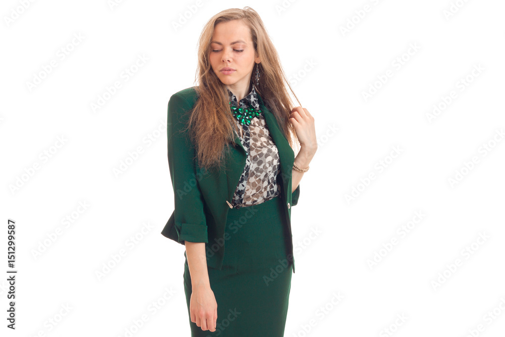 beautiful young blonde in a green suit lowered her eyes down and posing for the camera beautiful young blonde in a green suit lowered her eyes down and posing for the camera