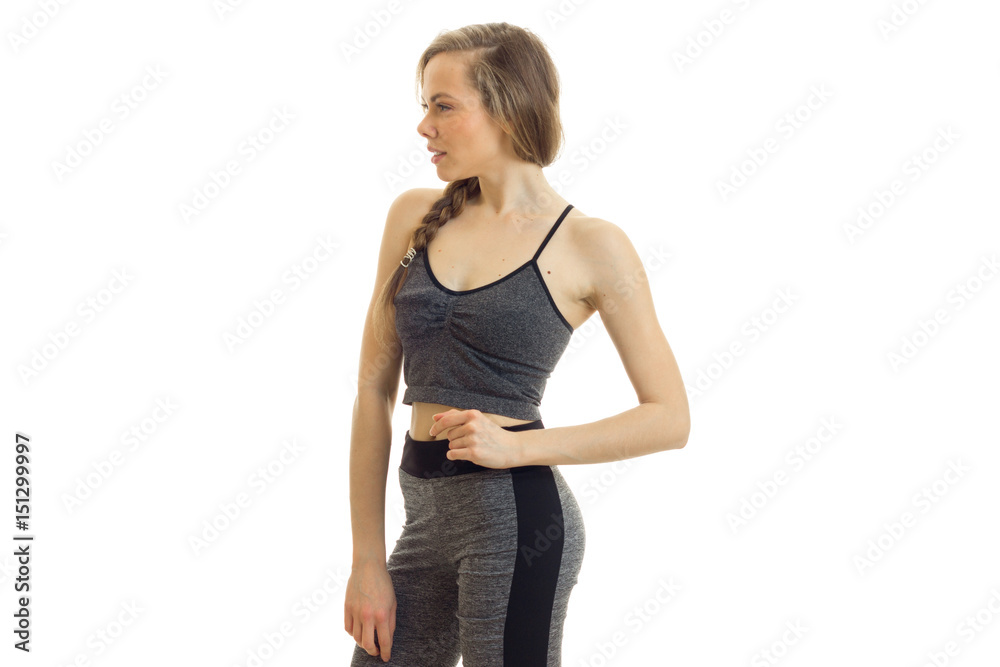 young slender fitness blonde looks away and keeps a hand on the side young slender fitness blonde looks away and keeps a hand on the side