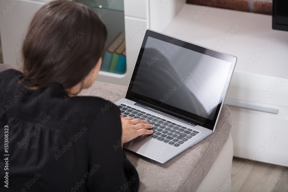 Rear View Of A Woman Using Laptop Rear View Of A Woman Using Laptop