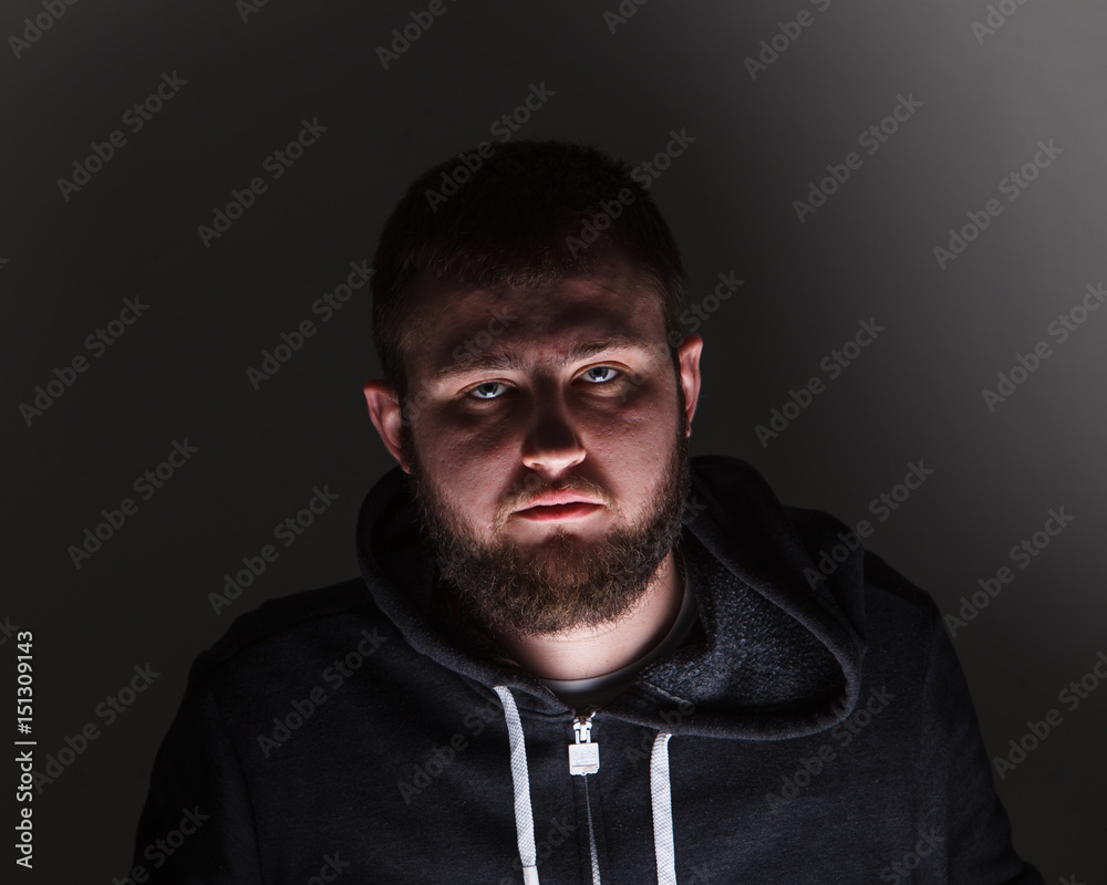 Portrait of a man with a beard in the dark
