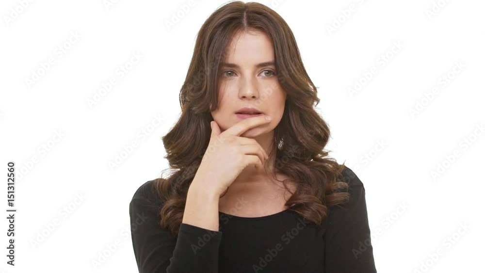 Thoughtful Caucasian brunette female standing on white background smoothng hair. Footage in slowmotion Thoughtful Caucasian brunette female standing on white background smoothng hair. Footage in slowmotion