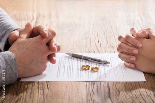 Couple's Hand On Divorce Agreement