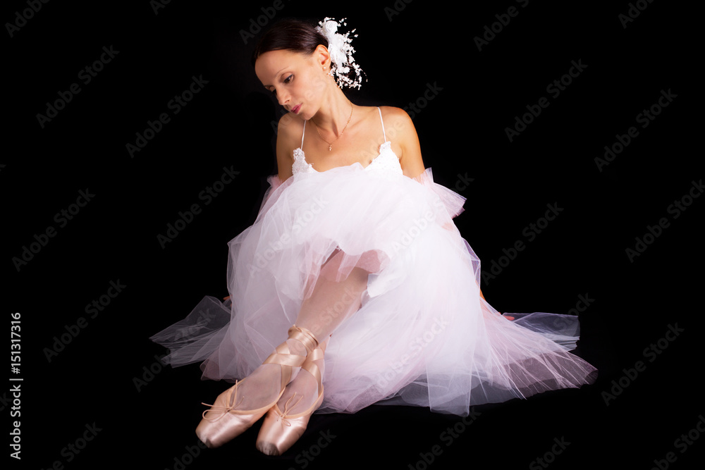 Fototapeta premium Beautiful ballet dancer posing on black background