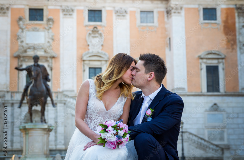 Bride and groom wedding poses in front of Capitol Hill (Campidoglio), Rome, Italy