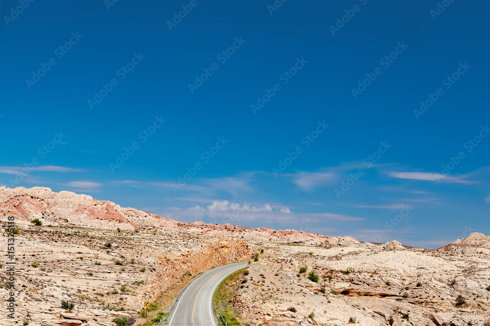 Desert Road winds through Monument Valley in Southwestern USA Desert Road winds through Monument Valley in Southwestern USA
