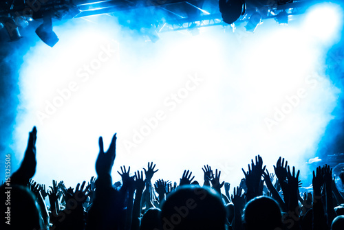 hands fans during a concert