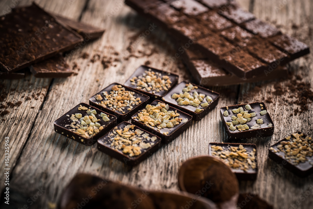 Chocolate bar pieces with cocoa powder. Background with chocolate. Slices of chocolate, Copyspace Chocolate bar pieces with cocoa powder. Background with chocolate. Slices of chocolate, Copyspace