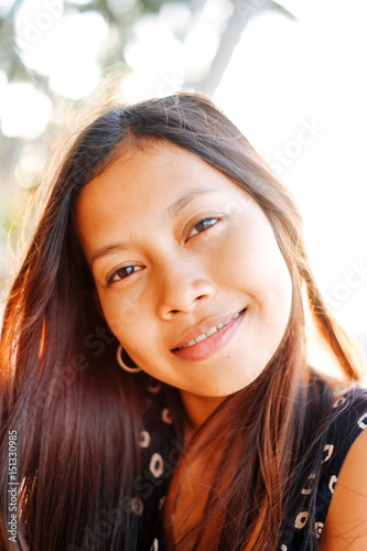 Portrait of a young woman with positive attitude smiling