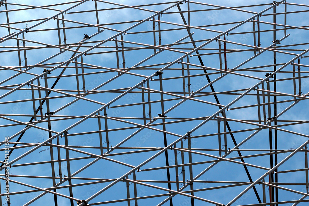 Metal scaffolding against blue sky background