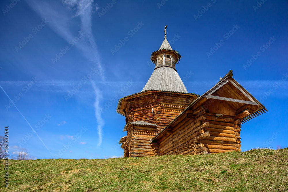 Spring view of the wooden Travel Tower of the Nikolo-Korelsky Monastery in the Kolomenskoye Museum at sunny day, Moscow, Russia