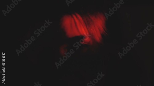 Rampage, frenzy, bloodthirsty emotion feel disco bloody party weird dance concept. Underground culture lifestyle. Formless young cool shaman female moves with strange magical flame red luminescence.