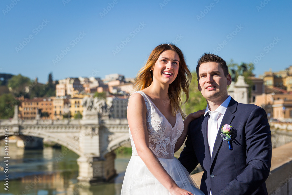Portrait of bride and groom posing on the streets of Rome, Italy