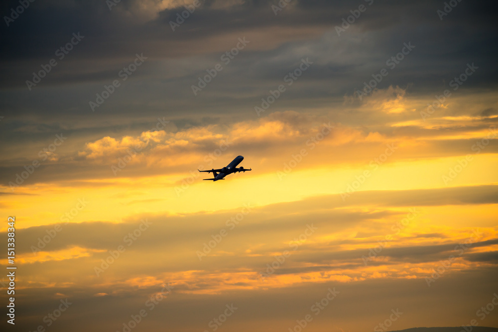 Silhouette of airplane at sunset...