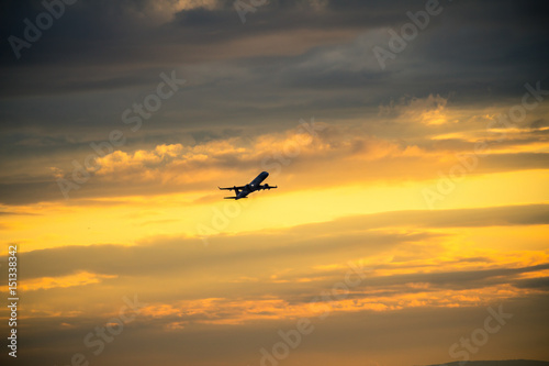 Silhouette of airplane at sunset... © robertdering