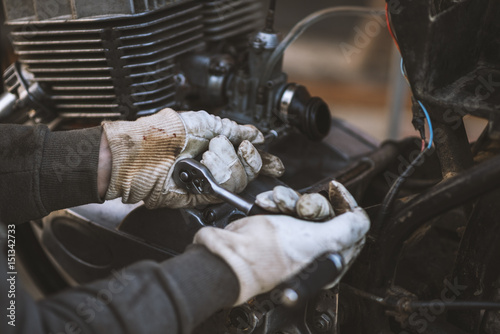Obraz na płótnie Process of caring and maintain an old motorcycle, retro