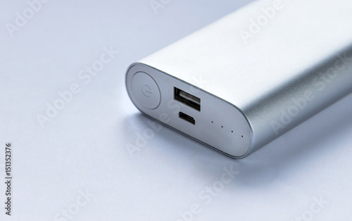 Grey portable external battery ( power bank ) . Selective focus