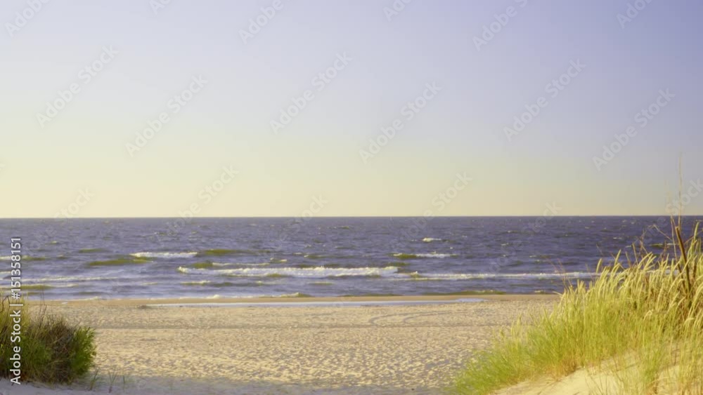 Summer vacation and resort. Empty entrance with green grass to sandy beach dunes. Seascape.4K ProRes HQ codec Summer vacation and resort. Empty entrance with green grass to sandy beach dunes. Seascape.4K ProRes HQ codec