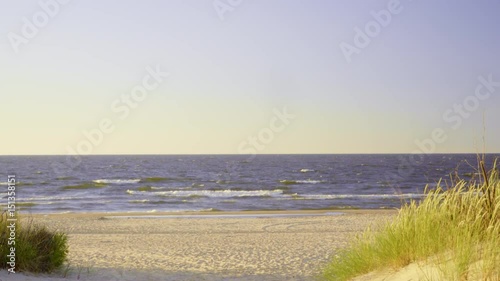 Summer vacation and resort. Empty entrance with green grass to sandy beach dunes. Seascape.4K ProRes HQ codec