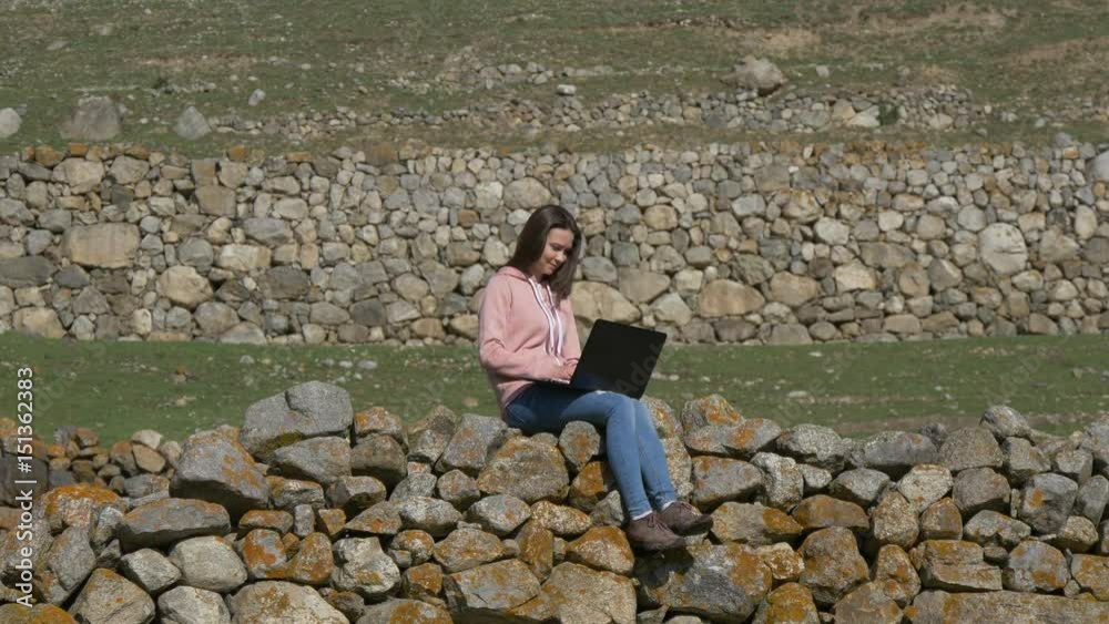Woman with laptop on the background of the ruins Woman with laptop on the background of the ruins