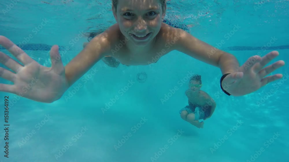 Kids jump into pool and go underwater