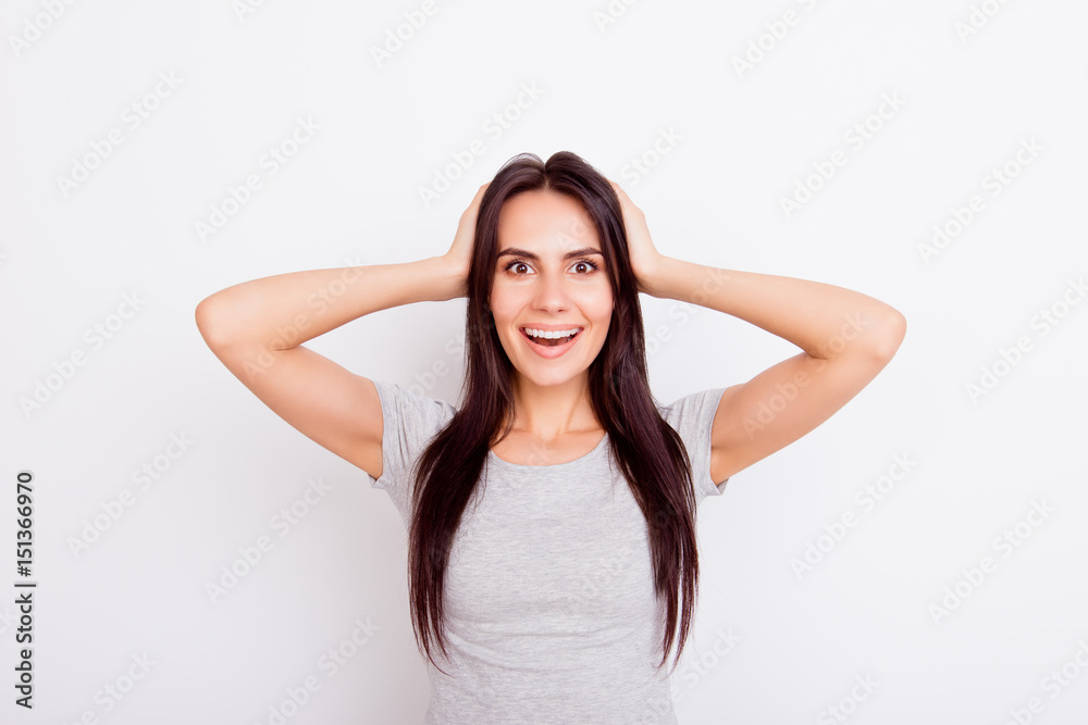 Wow! Really?! Close up portrait of cute amazed girl looking stright and holding her head, smiling, on white background Wow! Really?! Close up portrait of cute amazed girl looking stright and holding her head, smiling, on white background