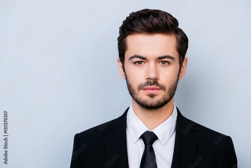 Close up portrait of handsome serious confident young manager in formal clothes isolated on gray background Close up portrait of handsome serious confident young manager in formal clothes isolated on gray background