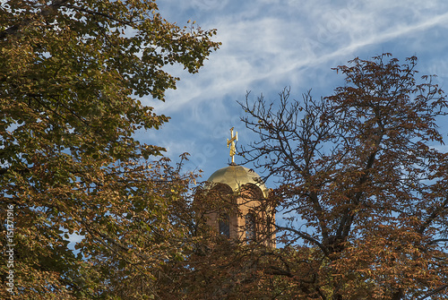 Blue sky clouds branches cross