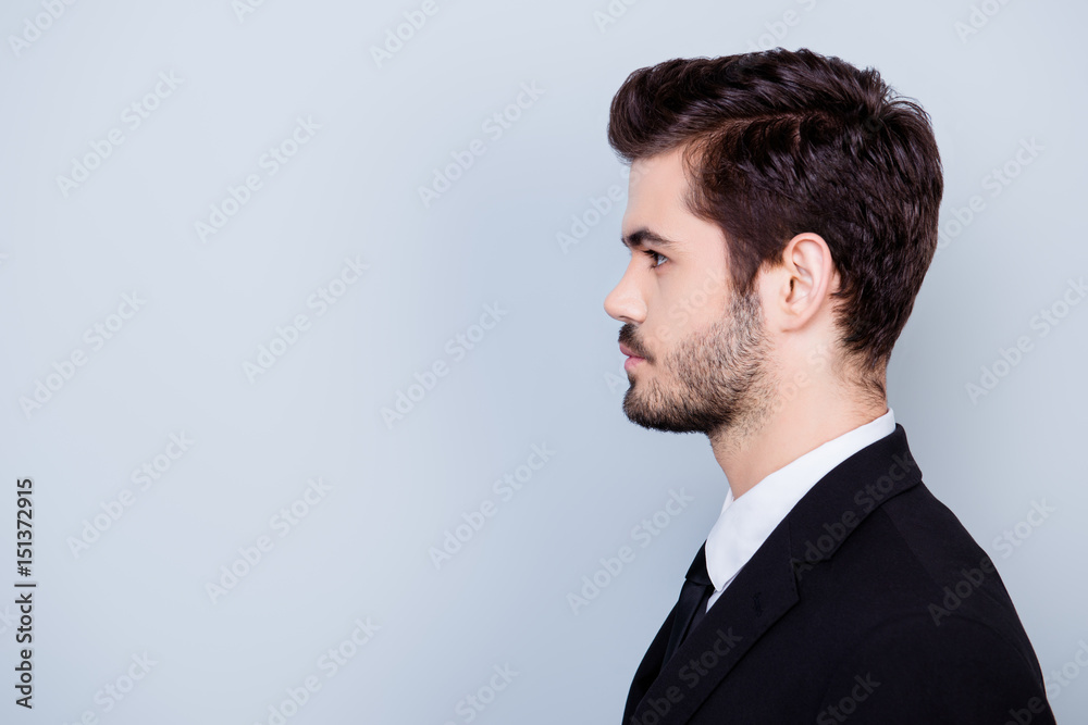 Side view portrait of serious concentrated hansome businessman in formal clothes isolated on gray background Side view portrait of serious concentrated hansome businessman in formal clothes isolated on gray background