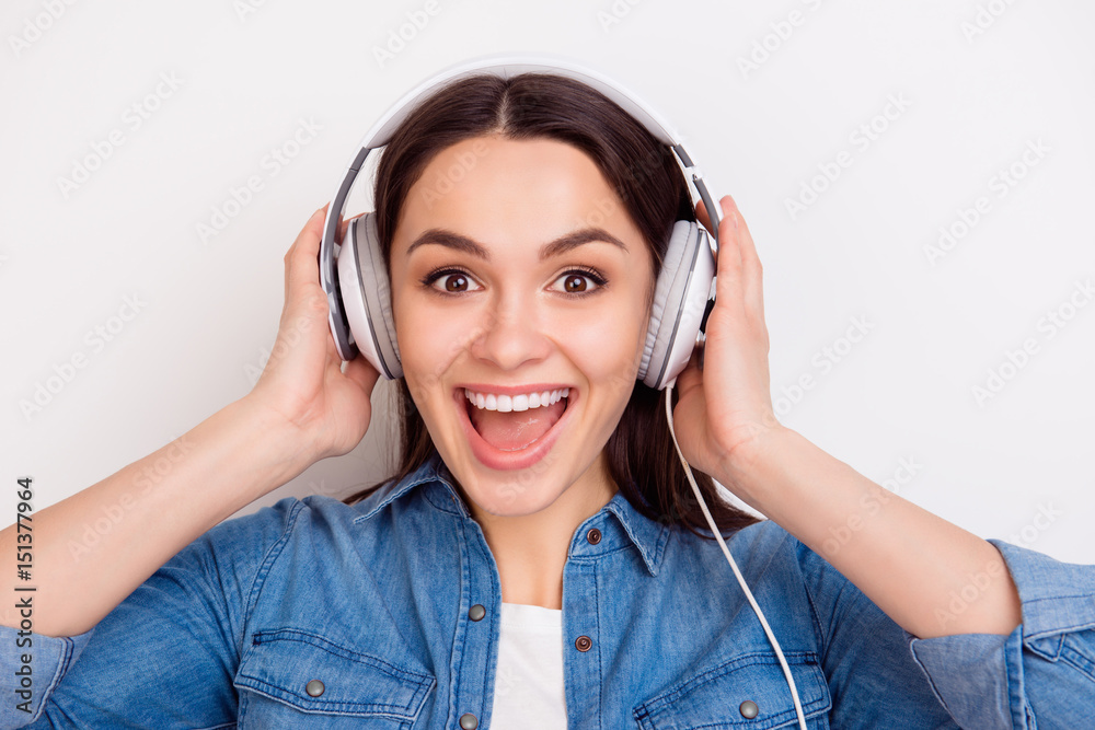 Close up photo of pretty excited woman in headphones listening to her favourite song and singing Close up photo of pretty excited woman in headphones listening to her favourite song and singing