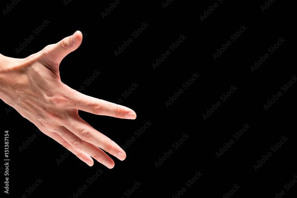 Male hand on a black background. Free space for text