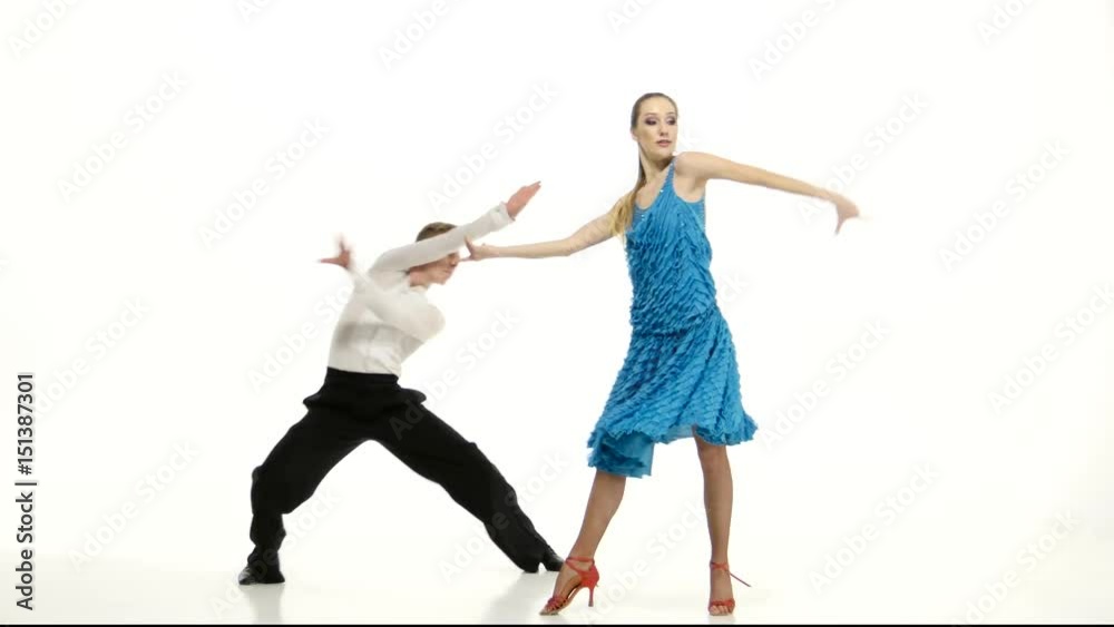 Couple of graceful dancers perform salsa on white studio background Couple of graceful dancers perform salsa on white studio background