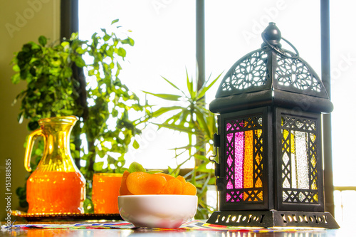 Table with Qamar El Din ( Apricots Juice) and Ramadan fanous (lantern) ready for happy breakfast in Ramadan photo