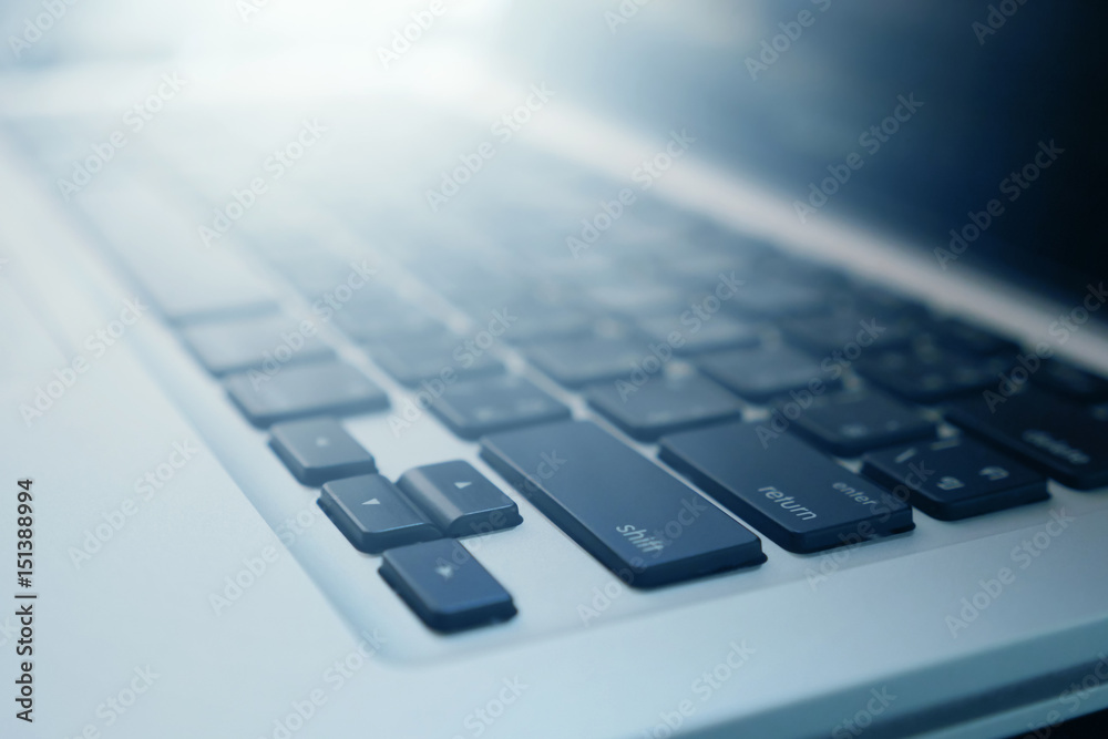 Close up of laptop keyboard with sunlight. selective focus