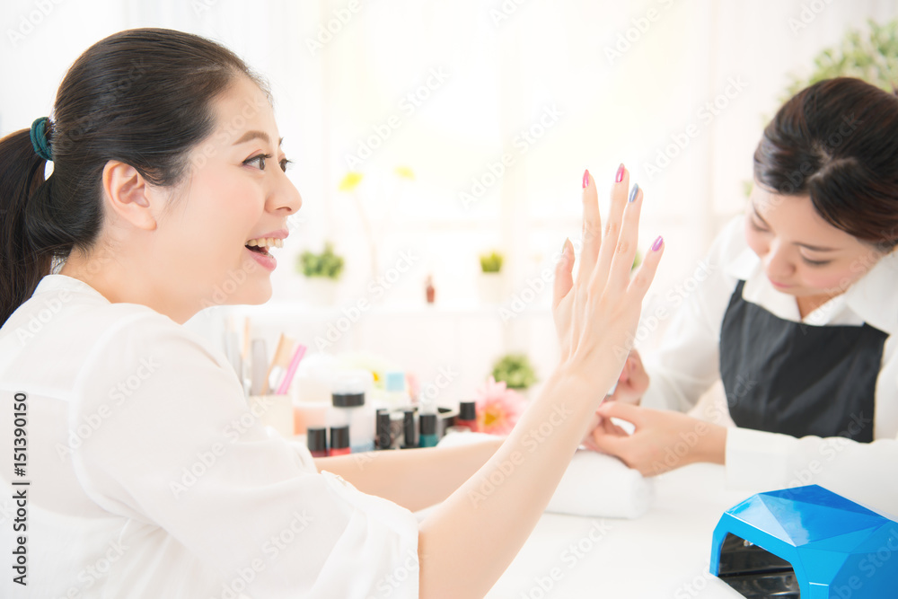 Fototapeta premium excited woman love her new done manicure