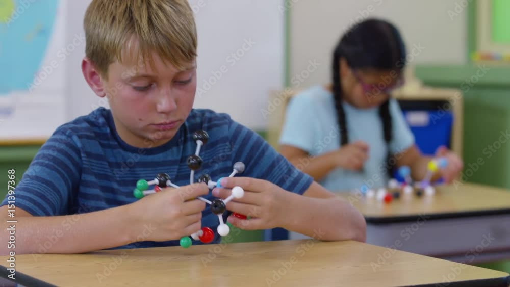 Children in school classroom building science models