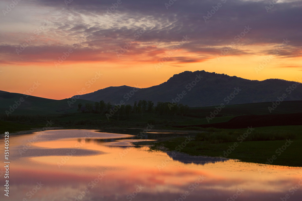 Landscape with sunset colorful lake reflections in the foothills of Altai Mountains Siberia Russia