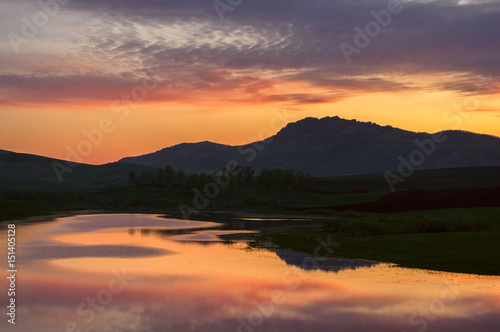 Landscape with sunset colorful lake reflections in the foothills of Altai Mountains Siberia Russia