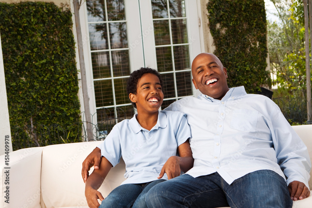 Fototapeta premium African American father and son talking and laughing.