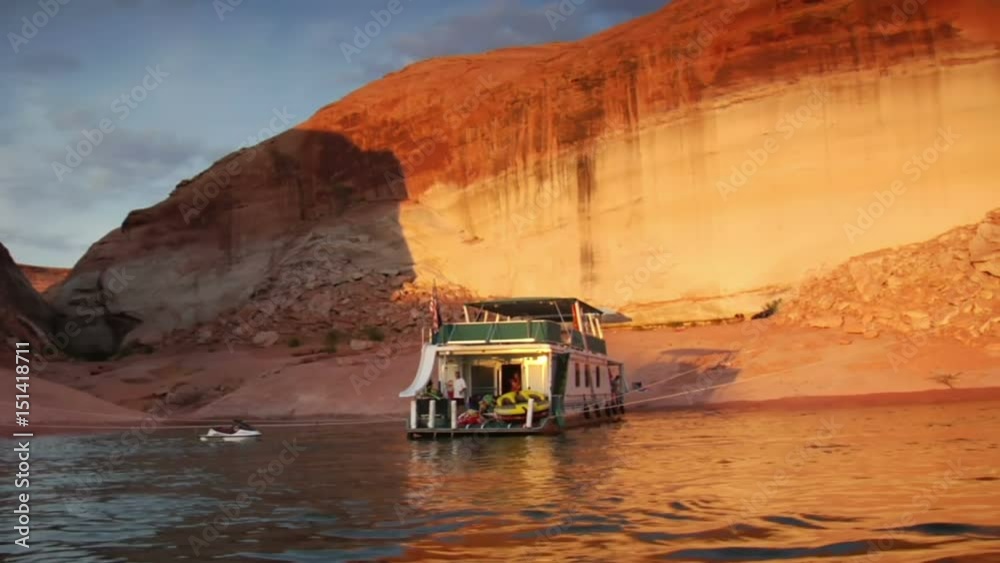 large houseboat docked in red rock canyon lake powell utah