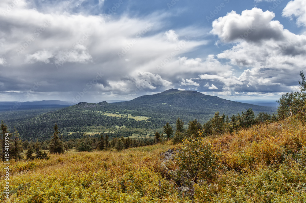 mountain landscape, the Ural Mountains, grass and mountain ranges, the weather changes, are storm clouds