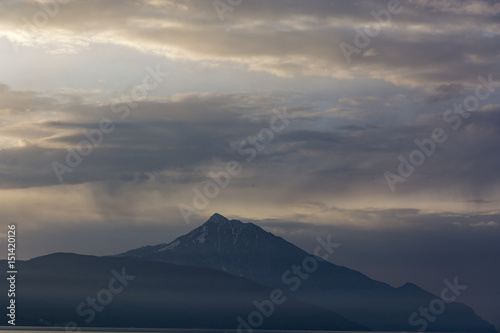 Beautiful sunset near the Aegean sea, coastline with mountains; in Greece, spring time