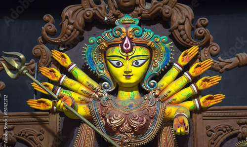 Durga idol in terracotta artistic style closeup portrait. Goddess durga is worshiped by Hindus in India and abroad and depicts victory of good over evil.