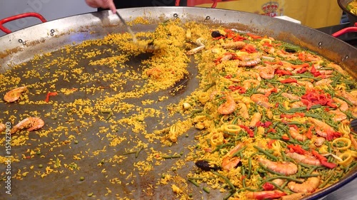 Large dish of Paella on a seafood market stall photo