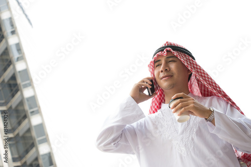 Happy Arabian man is standing in the city